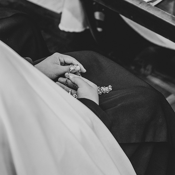 hands in a lap doing the rosary