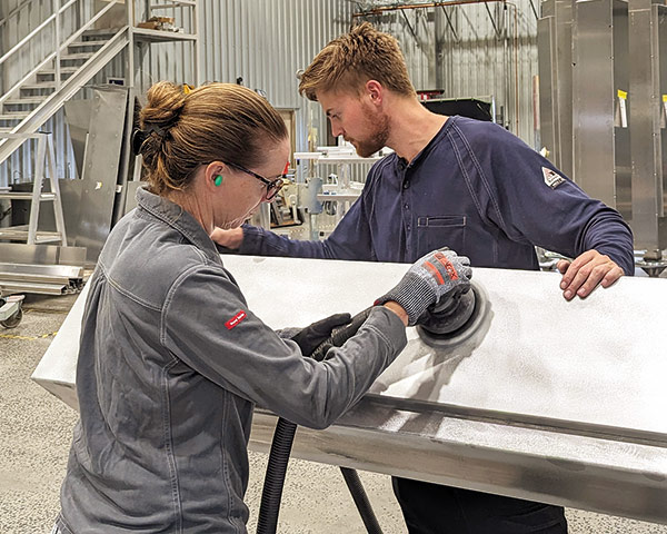 woman and her son metalworking