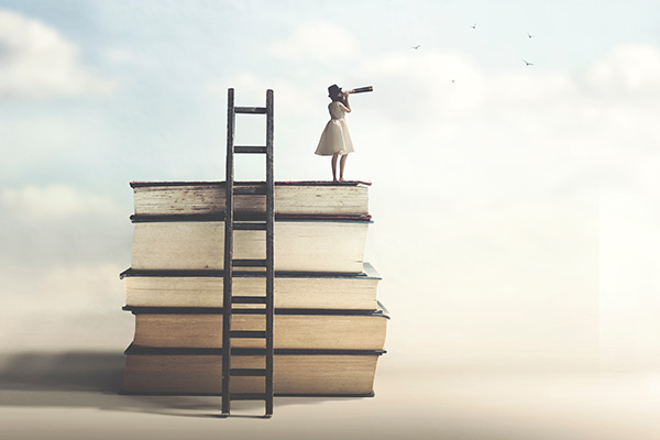 Man with spyglass on a stack of books