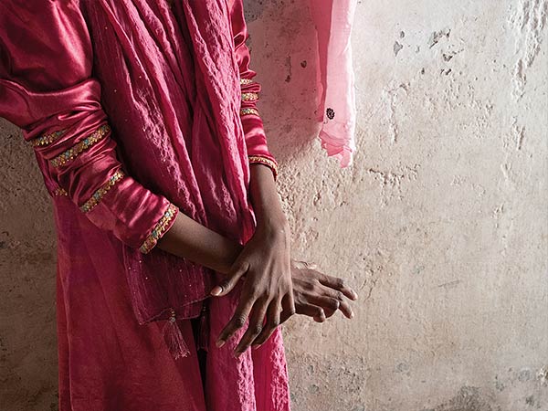 a woman standing with her arms crossed