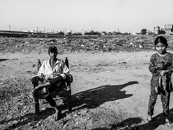 black and white photo of two kids on a road