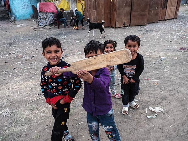 children holding a cricket bat