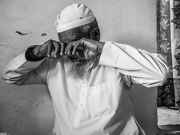 a man covering his eyes