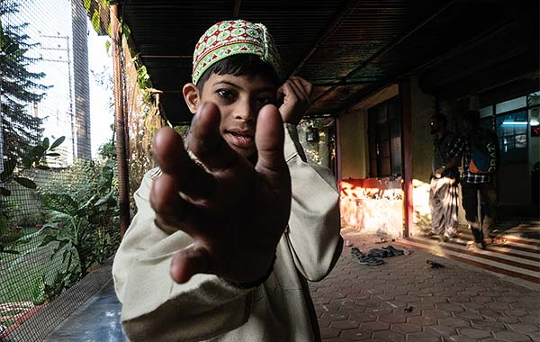 a young boy reaching out his hand