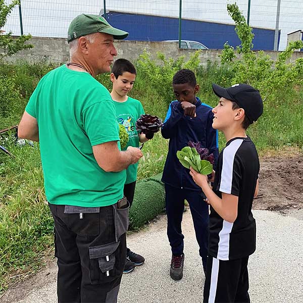 an older man talking with boys