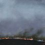 painting of bright houses in the night