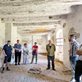 a group standing in the ruins of a former Hutterite community