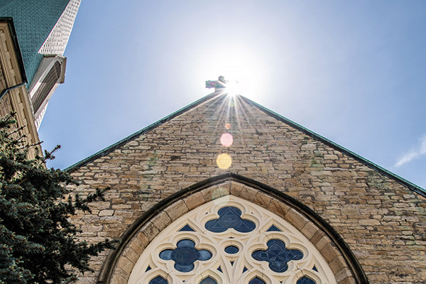 sun shining on the roof of a church