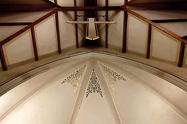 a cross on the ceiling of a church