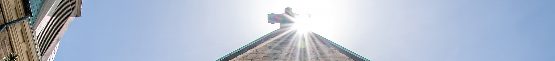 sun shining on the roof of a church