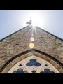 sun shining on the roof of a church