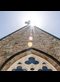 sun shining on the roof of a church