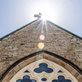 sun shining on the roof of a church
