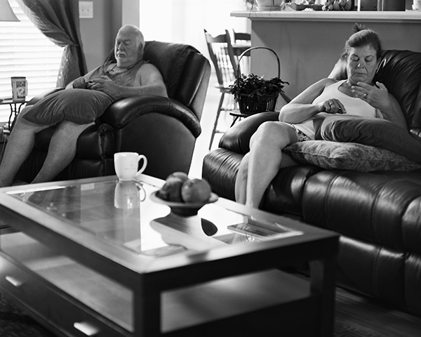 an old couple scrolling through their imaginary phones