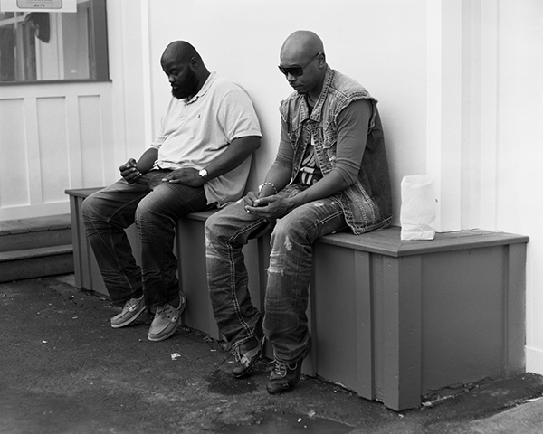two men looking down at imaginary phones