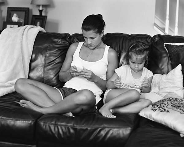 a mother and daughter looking at imaginary devices