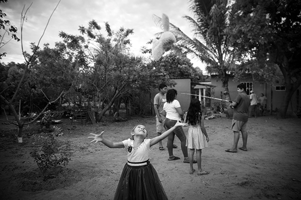 children playing outside a cottage