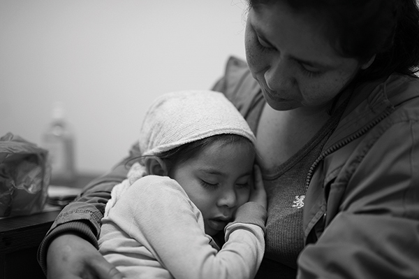 a mother holding a young child