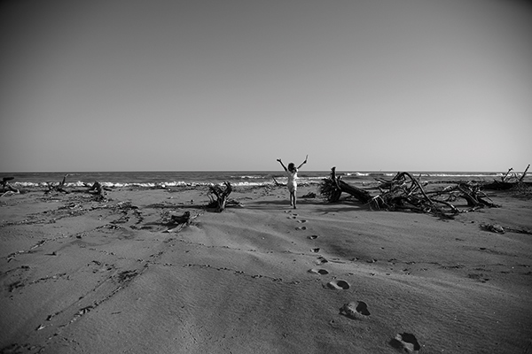 a girl running on a beach