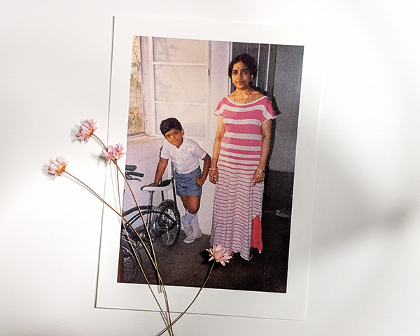 portrait of a boy standing by his mother