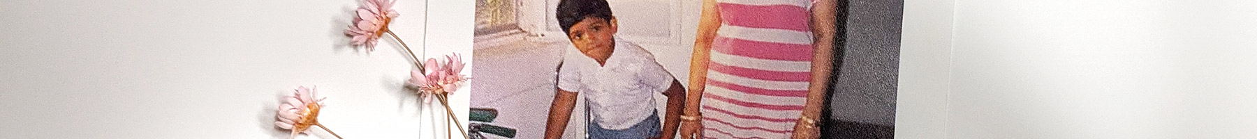 portrait of a boy standing by his mother