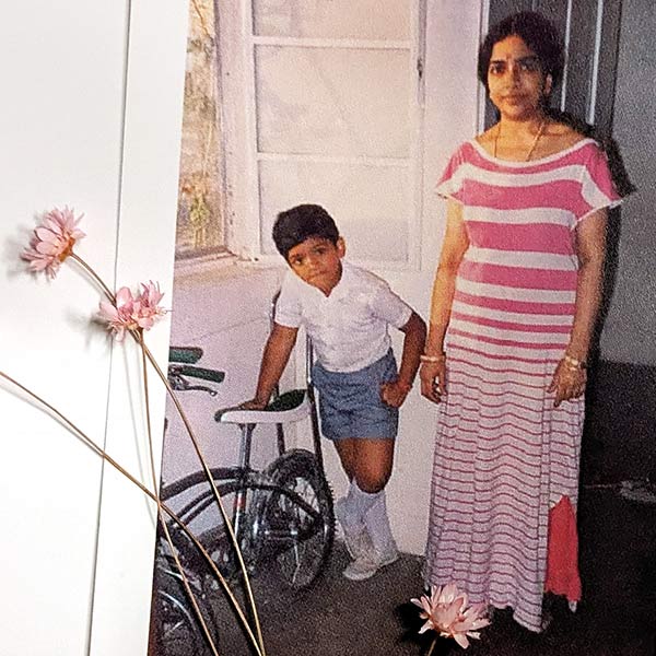 portrait of a boy standing by his mother