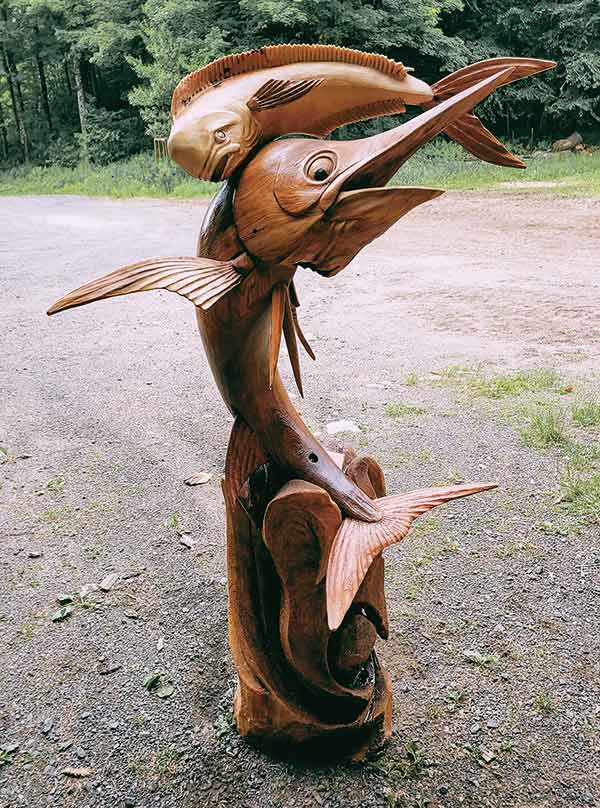 wood chainsaw sculpture of two fish