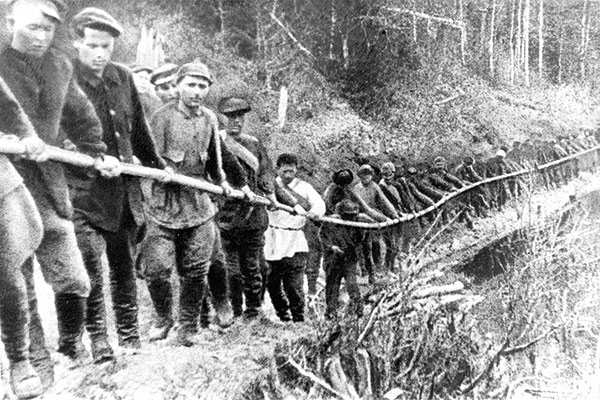 men pulling a rope to transport goods