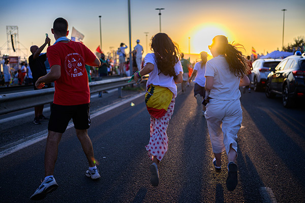 teenagers running down a road