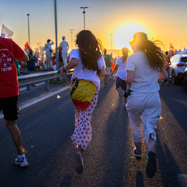teenagers running down a road