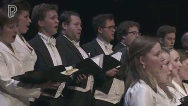 a choir dressed in black and white singing